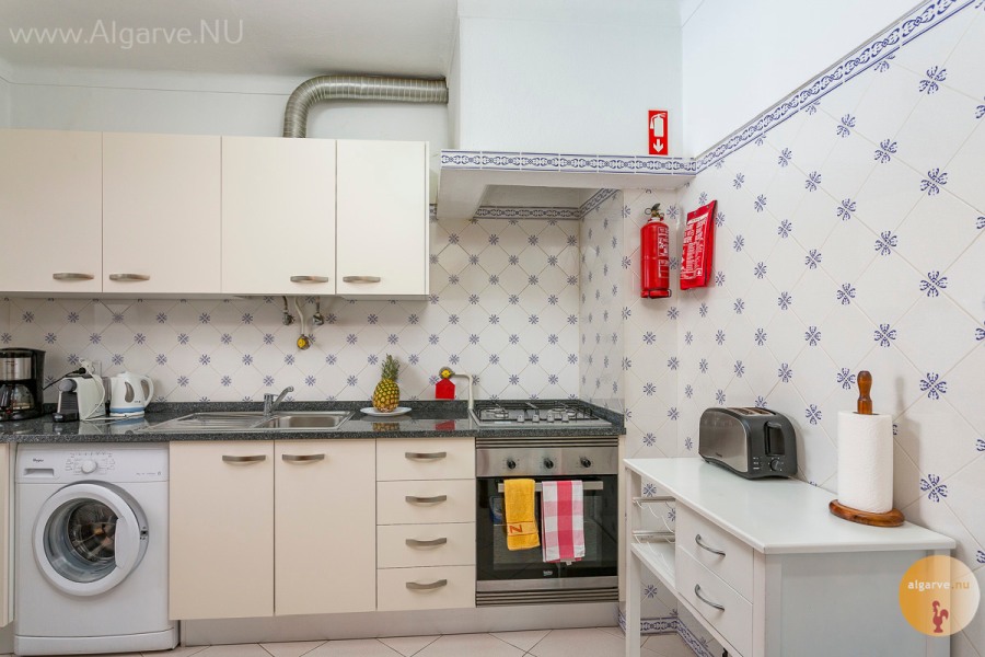 Kitchen with appliances and utility room / storage.
