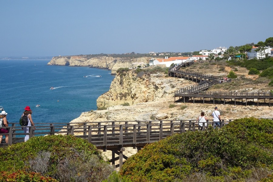The boardwalk over the rocky coast starts at the end of the street opposite from you. End in the center of Carvoeiro with sandy beach, boat rental, restaurants, and cozy terraces.