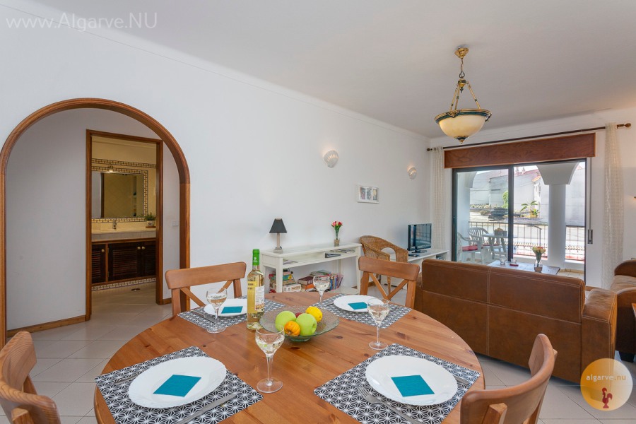 Dining area with extendable table and cupboard.